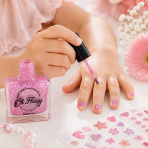 Close-up of pink glitter Oh Flossy Kids Nail Polish being applied