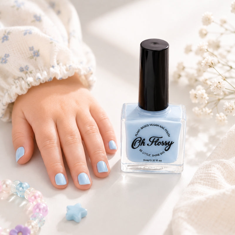 Child's nails painted with Oh Flossy Cream Blue Nail Polish