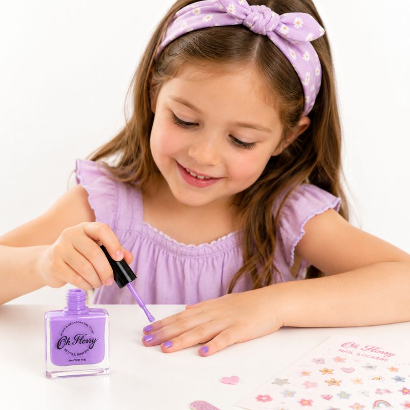 Child using Oh Flossy purple kids nail polish during creative play