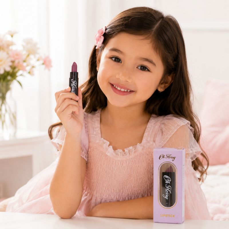 Child holding Oh Flossy Purple Natural Lipstick for Kids during pretend beauty play