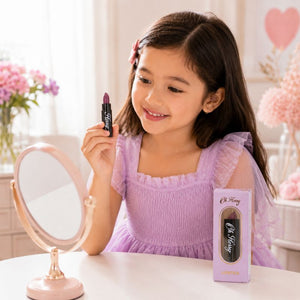 Child using Oh Flossy Purple Natural Lipstick during dress-up play with a mirror