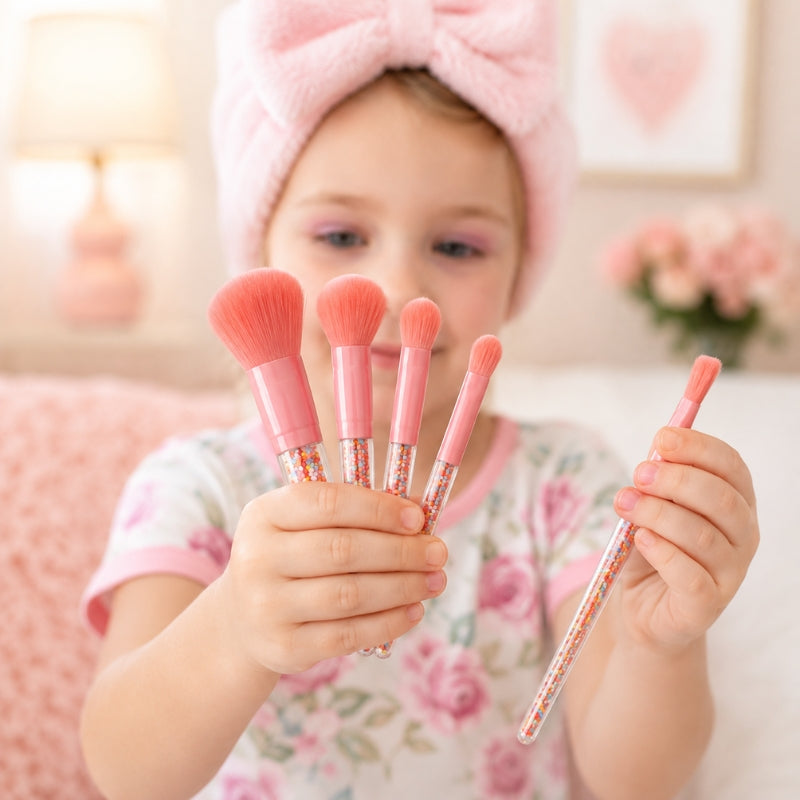 Happy child holding five Oh Flossy Sprinkle Makeup Brushes for creative play