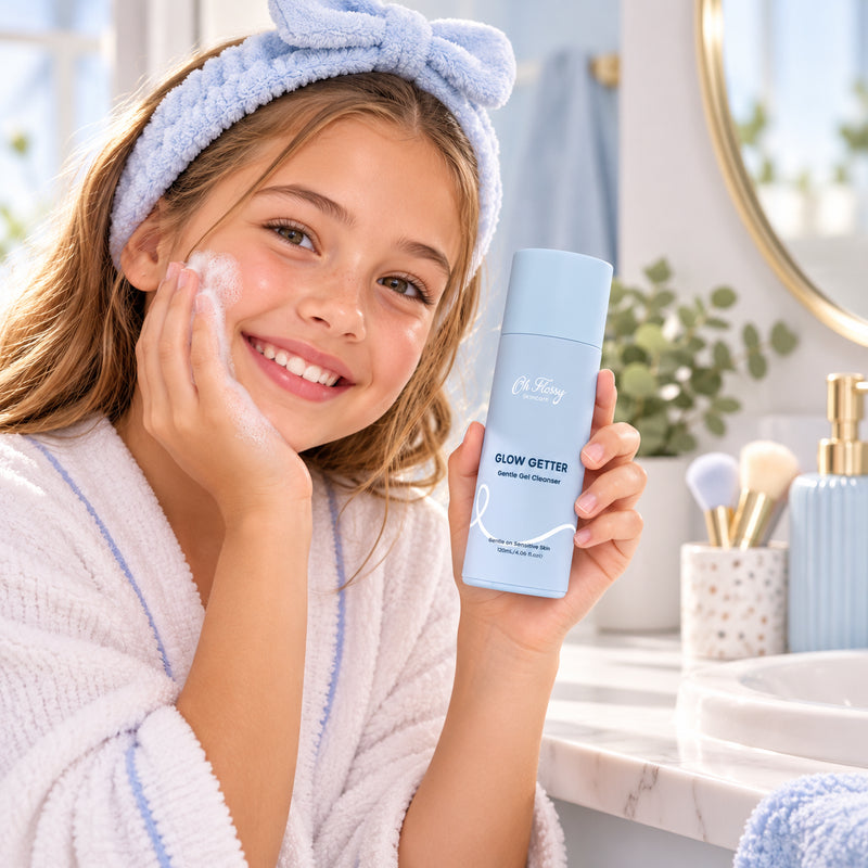 Young girl enjoying her skincare routine while holding Oh Flossy Glow Getter Gentle Gel Cleanser in a bright bathroom.