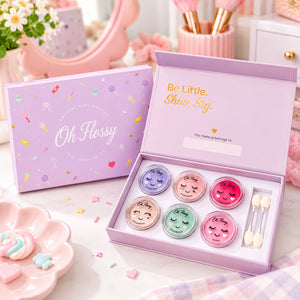 Oh Flossy Sweet Treat Make Up Set displayed on a pastel pink vanity with colourful kids makeup, brushes and playful accessories.