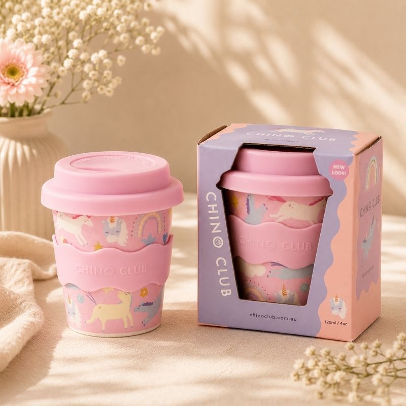 Pink Unicorn Babychino Cup, 4 oz, with lid and packaging on a neutral background