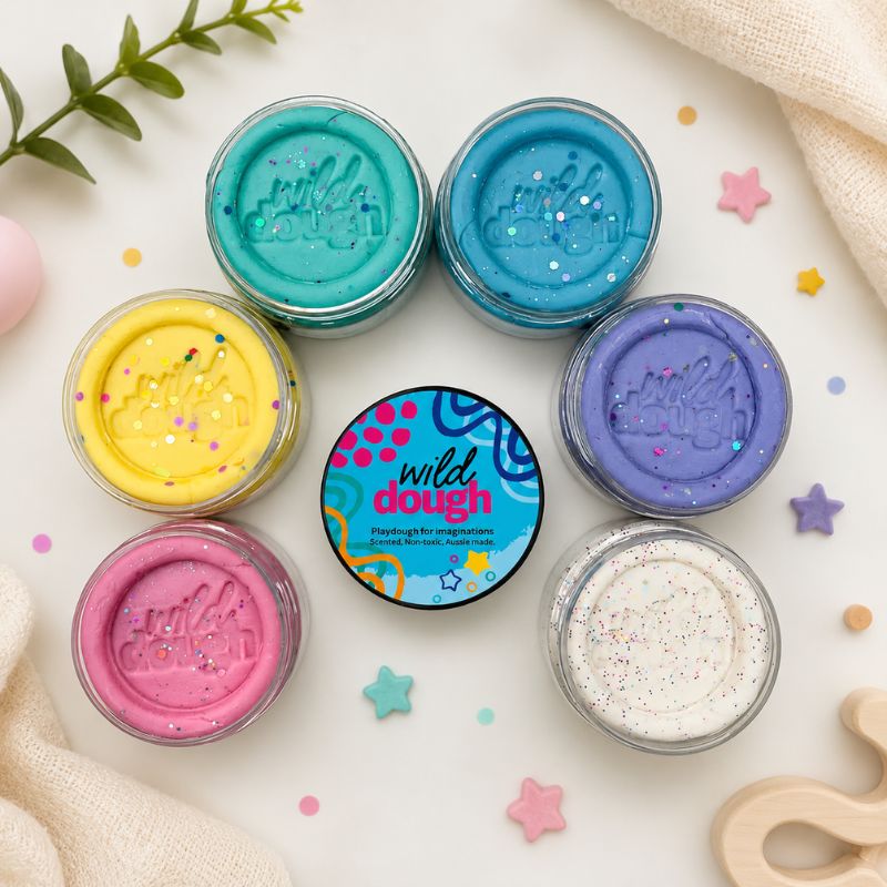 Assorted jars of wild dough with colorful lids on a light background