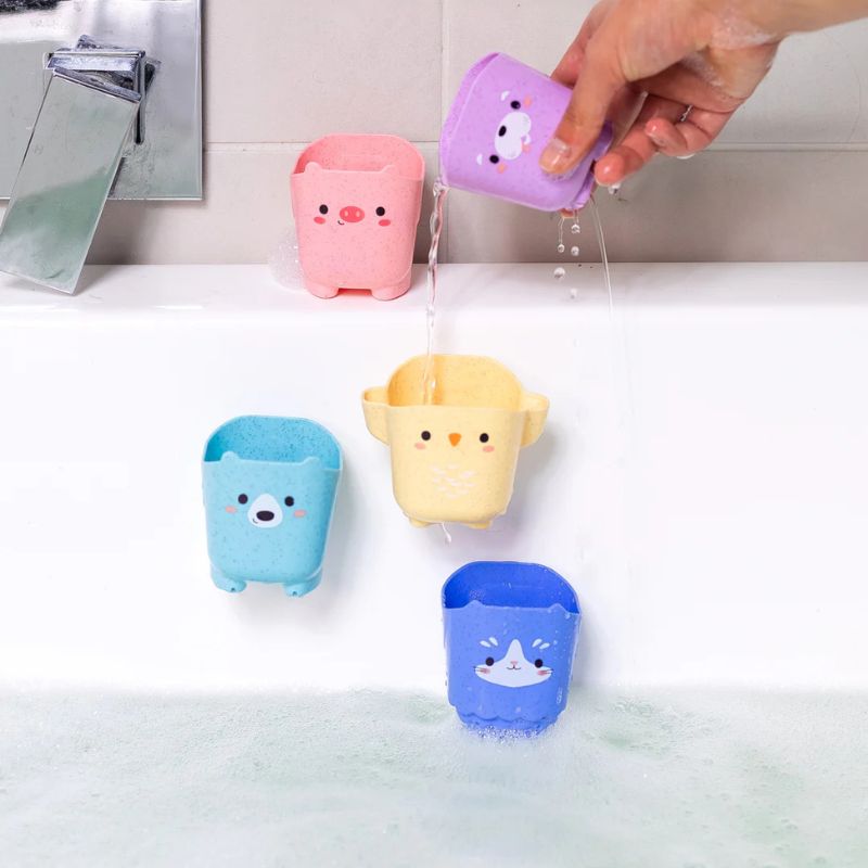 Hand playing with animal bath cups demonstrating water play feature
