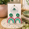 Handmade Rainbow Dangle Earrings featuring colorful rainbow arches with green floral stud tops crafted from lightweight polymer clay by Love Shack Giftware.