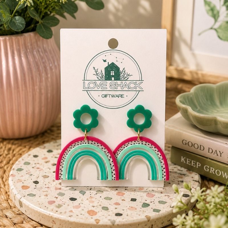 Handmade Rainbow Dangle Earrings featuring colorful rainbow arches with green floral stud tops crafted from lightweight polymer clay by Love Shack Giftware.