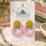 Pair of Retro Bloom Dangle Earrings on a 'Love Shack Giftware' card with books and plants in the background.