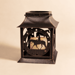 Rustic metal horse lantern candle holder with horse silhouette and star cutout details on a clean beige background.