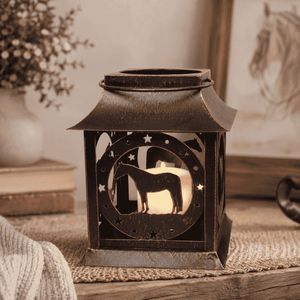 Decorative horse silhouette lantern in a warm farmhouse setting with ceramic vase and rustic home accessories.
