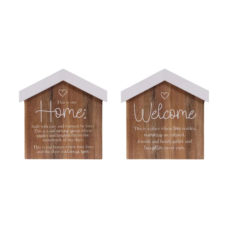 Two small house-shaped wooden wall signs with white roofs and white script text, shown side by side on a plain white background. One sign says "Home" and the other says "Welcome by Saddle & Bloom.
