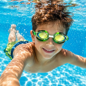 Young boy swimming underwater wearing Rattlesnake Royal Serpent swim goggles with mirrored lenses