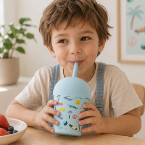 A child drinking from a Skater Mini Smoothie Cup & Straw 200 ml in a home setting