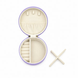 A Small Travel Jewellery Case_Violet with a lavender purple exterior and cream-colored interior compartments, shown on a white background with two wooden tools beside it.