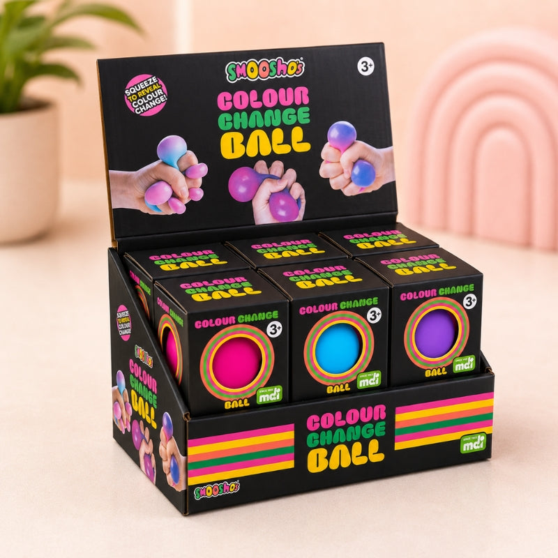 A black retail display box of Squeezzoids Colour Change Balls, showing three balls inside (one pink, one blue, one purple) with a black lid displaying the product name and usage instructions.