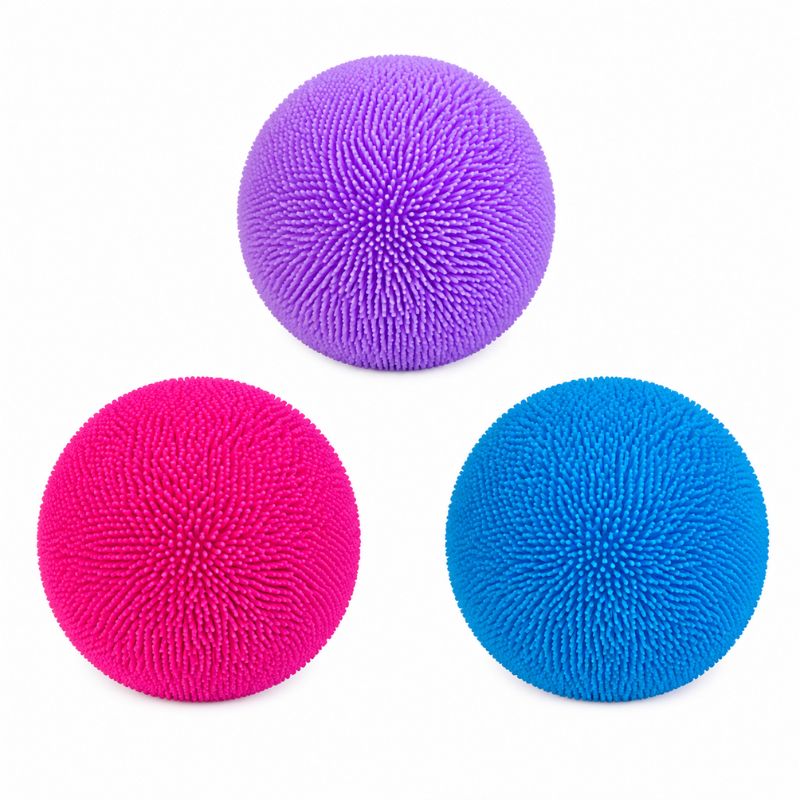 Three textured stress balls in purple, pink, and blue, arranged in a triangle on a white background.