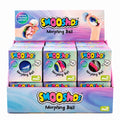 A retail display box filled with multiple Smooshos Morphing Ball mystery toy packages. The display box and individual boxes feature pastel pink, purple, and blue gradient packaging with the 'Smooshos' logo and a circular window showing the colorful morphing ball inside.