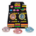A retail display box of mdi Super Squeeze Glow Diamond glow-in-the-dark slime, shown with three loose glow diamonds in pink, blue, and clear glitter in front of the black display stand on a white background.