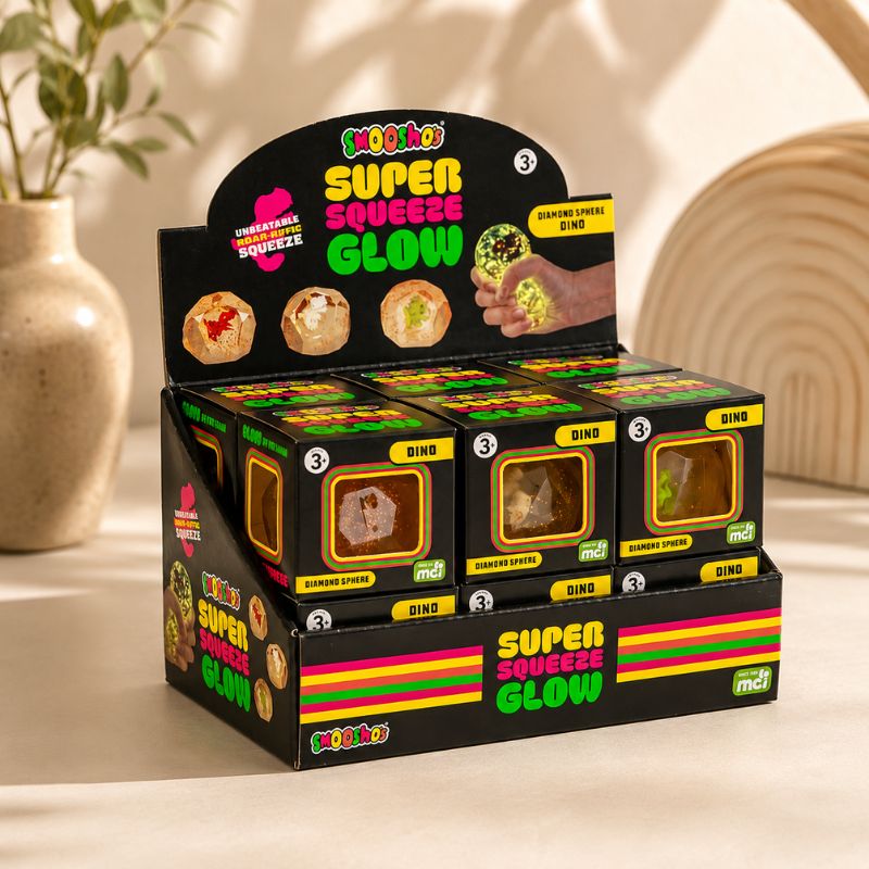 Smooshos Super Squeeze Glow Diamond Sphere Dino countertop display with premium lifestyle styling