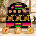 Smooshos Super Squeeze Glow Diamond Sphere Dino retail display in a modern tabletop setting