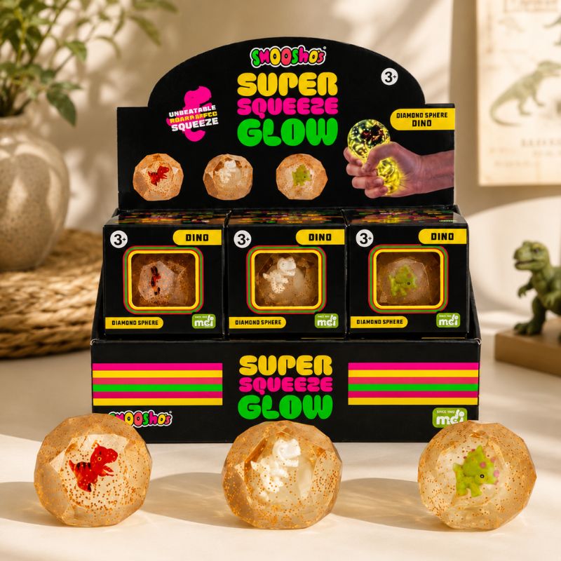 Smooshos Super Squeeze Glow Diamond Sphere Dino retail display in a modern tabletop setting