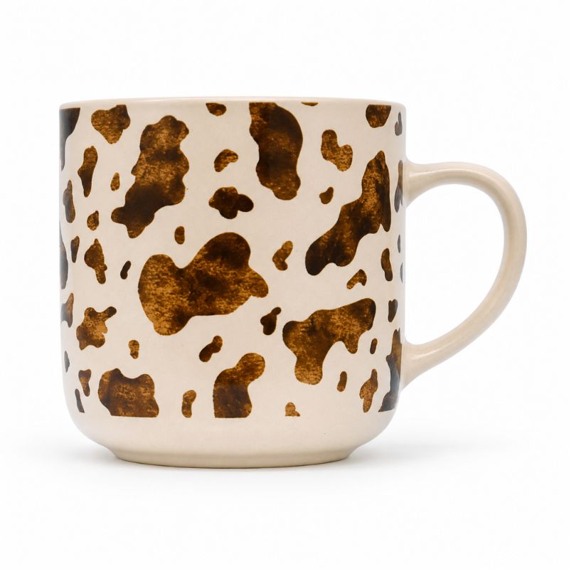 Splosh - Saddle & Bloom Cow Mug on a cream-colored base, featuring a curved handle on the right side.