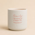 Splosh ceramic planter with “Family the roots of a happy life” quote on beige background