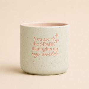 Sage green ceramic quote planter with “You are the spark that lights up my world” text on beige background