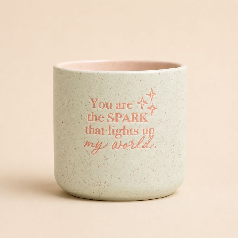 Sage green ceramic quote planter with “You are the spark that lights up my world” text on beige background