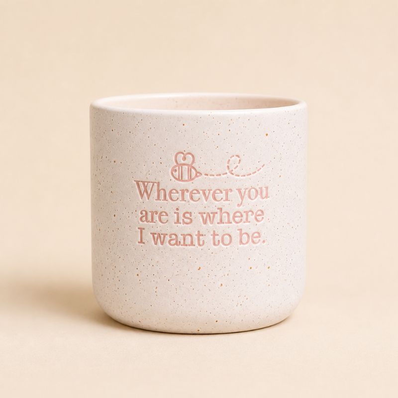 Neutral ceramic quote planter with “Wherever you are is where I want to be” on beige background