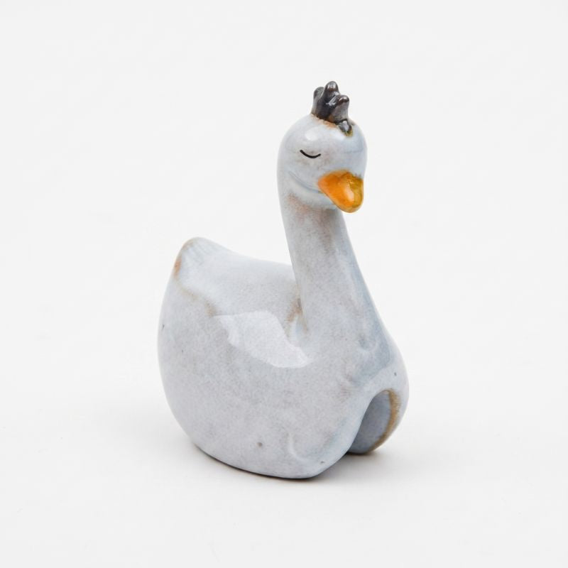 A small ceramic duck figurine with a light gray-blue glazed body, a bright orange beak, and a dark gray crown, shown on a plain white background.-Swan Pot Hanger White 9cm
