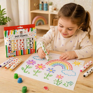 Child drawing with dot paints on a sheet of paper, surrounded by Tiger Tribe dot paint markers and a box of dot paints. - Loveshack Giftware