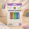 Packaging of Tiger Tribe Shimmer Markers on a wooden surface with markers and rainbow decorations. - Loveshack Giftware