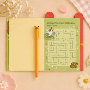 Children's book with a maze and pen on a soft pink background