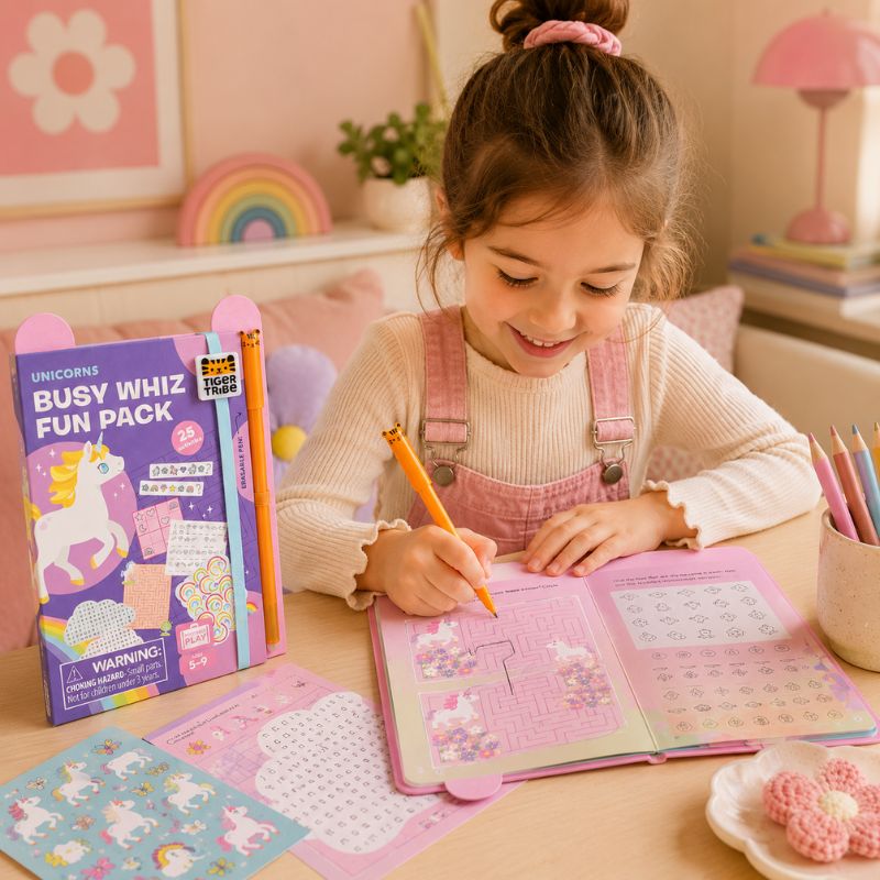 Young girl engaged in an activity book  Busy Whiz Fun Pack with colorful pencils in a cozy room. - Loveshack Giftware