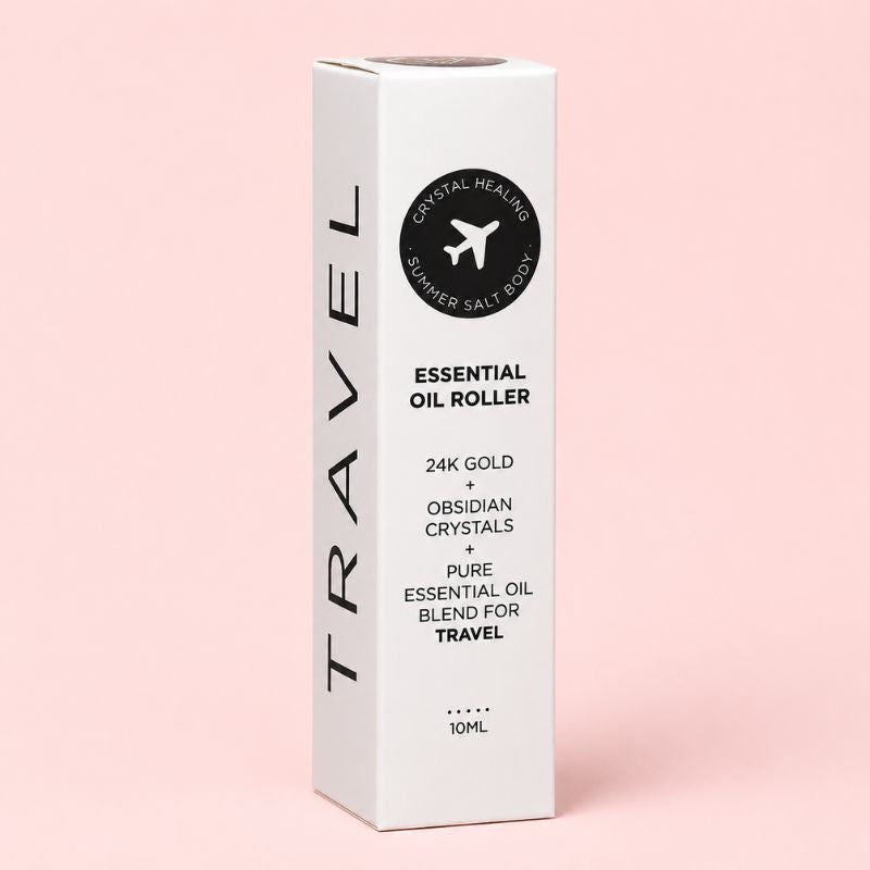 White essential oil roller packaging with black text on a pink background