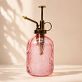 Pink glass spray bottle with brass nozzle on a beige background-Loveshack GIftware