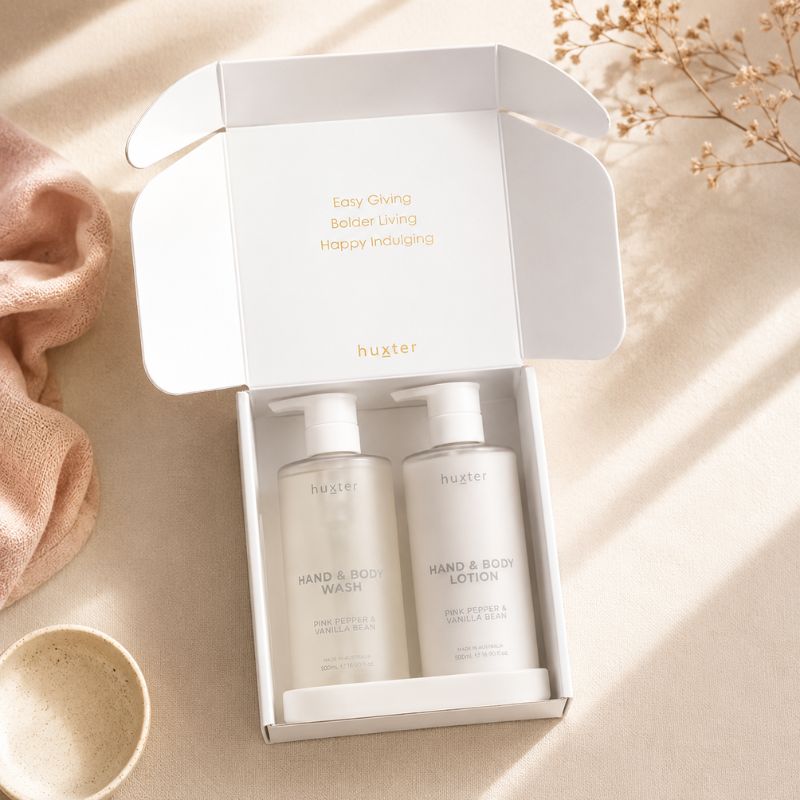 Open Huxter Wash and Lotion Gift Set with Pink Pepper & Vanilla Bean pump bottles in premium gift packaging