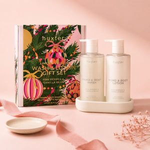 Huxter Pink Pepper & Vanilla Bean Hand and Body Wash and Lotion Gift Set styled on a soft blush background