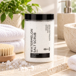 Summer Salt Body Watermelon Salt Scrub styled on a light stone bathroom vanity