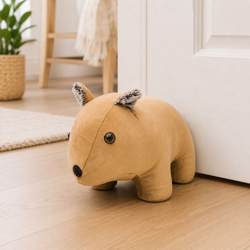 Wombat door stopper on a wooden floor