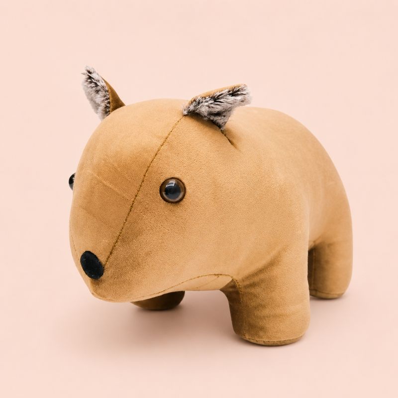 Wombat door stopper resembling a small animal on a beige background