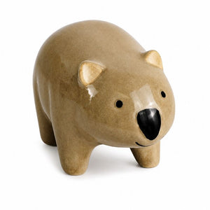 A ceramic polar bear figurine in a matte tan glaze with a glossy black nose and small black eyes, standing on a white background.-Wombat Pot Hanger