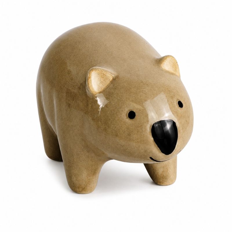 A ceramic polar bear figurine in a matte tan glaze with a glossy black nose and small black eyes, standing on a white background.-Wombat Pot Hanger