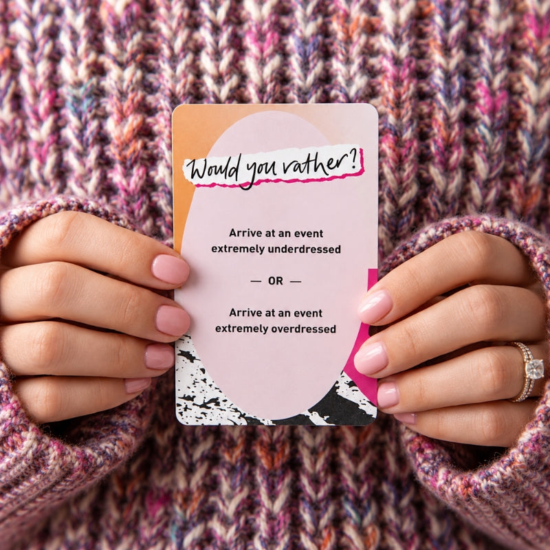 Person holding a Would You Rather card against a colourful knit background